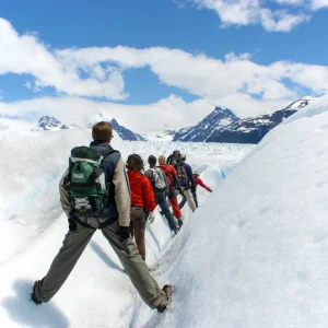 groupe de personne progressant dans la neige avec leur sac d'hiver
